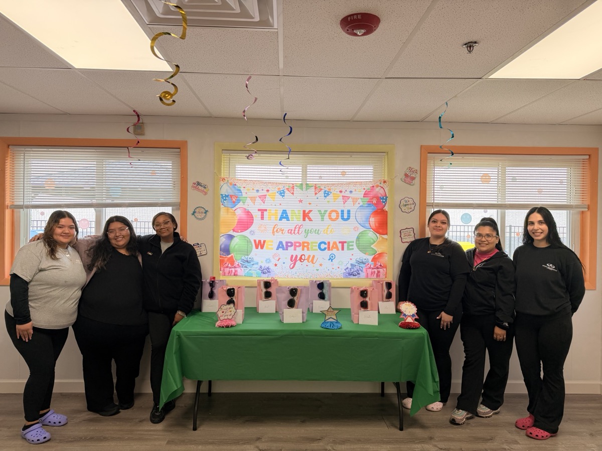 The Ogden team gathered around the appreciation gift table